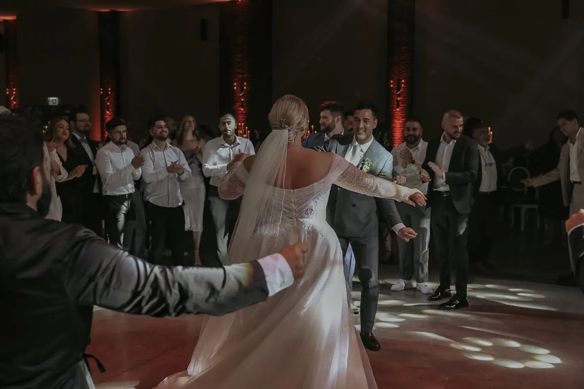 Die Braut mitten im Kreis bei den t&uuml;rkischen T&auml;nzen der deutsch-t&uuml;rkischen Hochzeit im Lavie bei K&ouml;ln